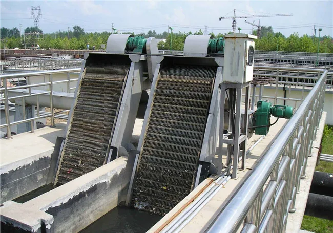 Mechanical rake screens installed in an open inlet channel, with the drives above the water line